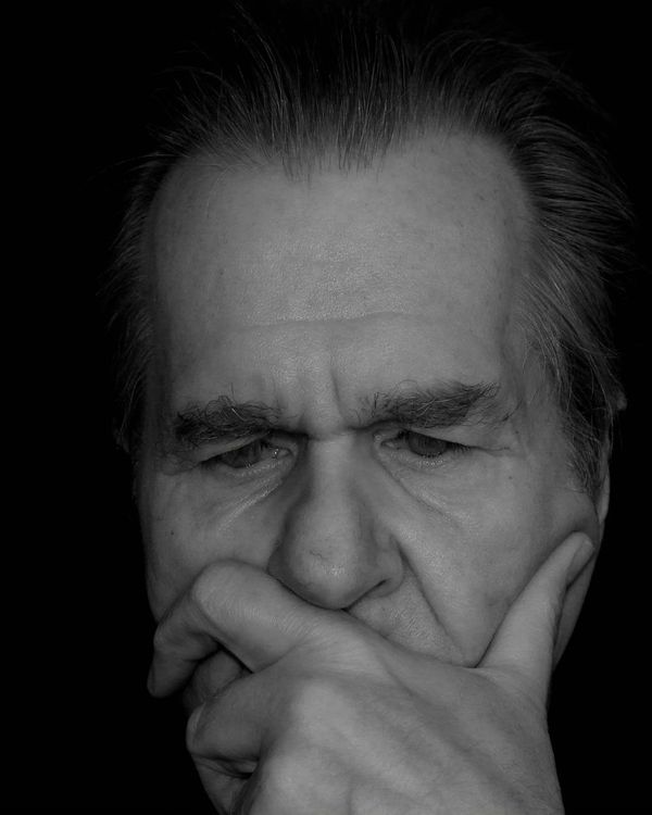 Close-up of a person's serene face with eyes closed, symbolizing deep breathing.